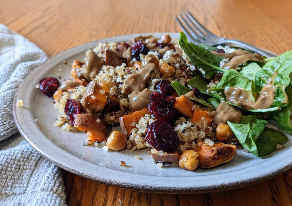 Quinoa sweet potato power bowl with avocado balsamic dressing