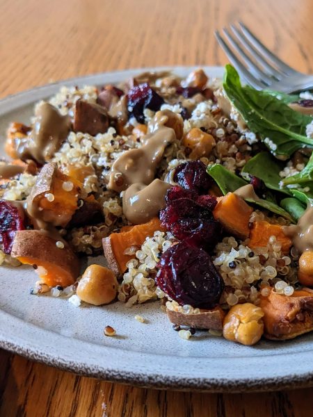 Quinoa sweet potato power bowl with avocado balsamic dressing
